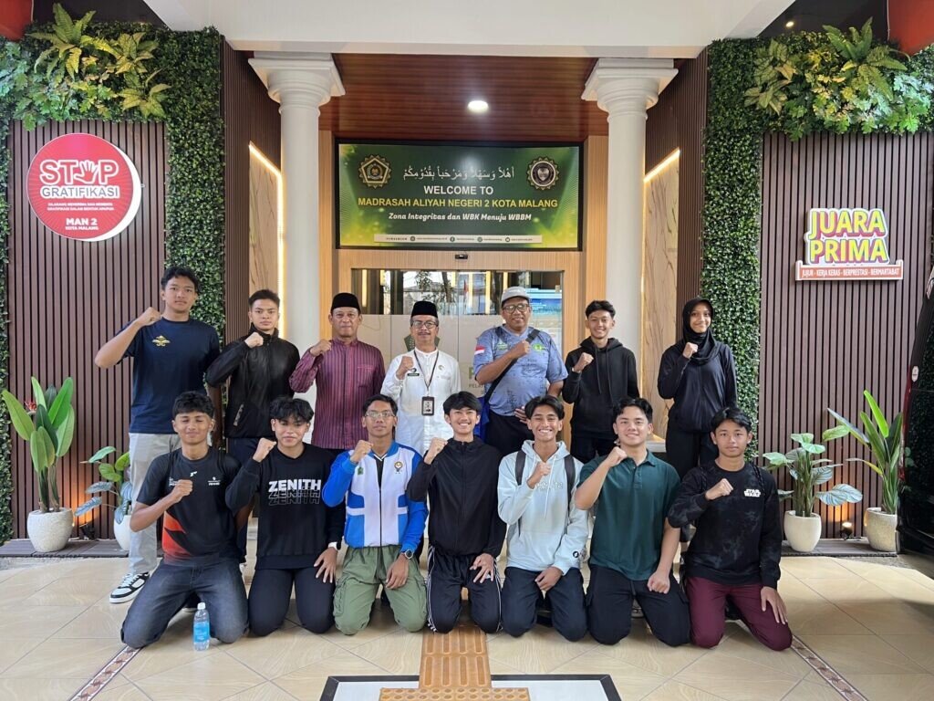 Potret kebersamaan Kepala MAN 2 Kota Malang, jajaran guru pendamping, dan para siswa tim atletik di depan area PTSP sesaat sebelum bertolak menuju arena perlombaan di Surabaya