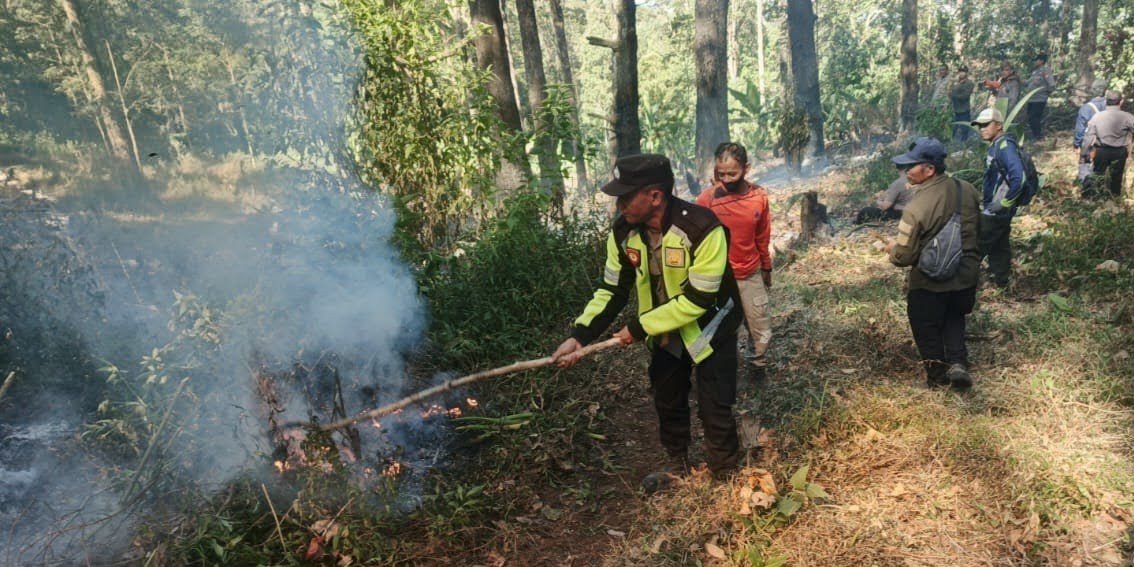 Kerja sama Polisi, Perhutani, dan warga untuk memadamkan kebakaran di kawasan lereng Gunung Lawu, Minggu (6/9)./dok.HUM-DNY