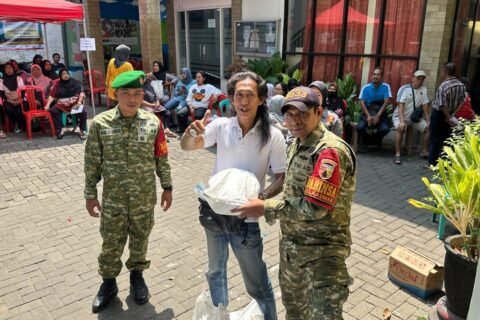 Momen antusias seorang warga yang mengacungkan jempol usai menerima paket bantuan pangan, didampingi langsung oleh Babinsa Kauman untuk memastikan kelancaran dan ketepatan sasaran distribusi.