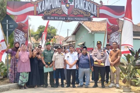 Potret antusiasme dan kebersamaan warga bersama elemen pemerintah desa, TNI, serta Polri di bawah gapura Blok Pilanan saat menyambut tim penilai Lomba Kampung Pancasila di Desa Penunggul.