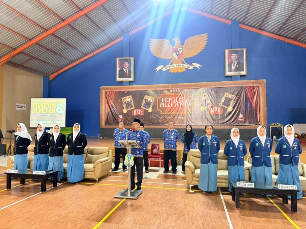 Kepala SMAN 1 Turen tengah memberikan sambutan sekaligus arahan di hadapan para kandidat pasangan calon (paslon) dan warga sekolah dalam pembukaan Pemilihan Ketua OSIS (Pilketos) dan Ketua Umum (Pilketum).