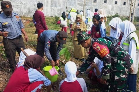 Momen kebersamaan personel Koramil 0833-03/Blimbing bersama petugas Linmas dan siswa-siswi SMPN 24 Malang saat bergotong royong menanam bibit pohon di Kelurahan Polowijen sebagai wujud aksi Karya Bakti memperingati HUT ke-81 TNI.