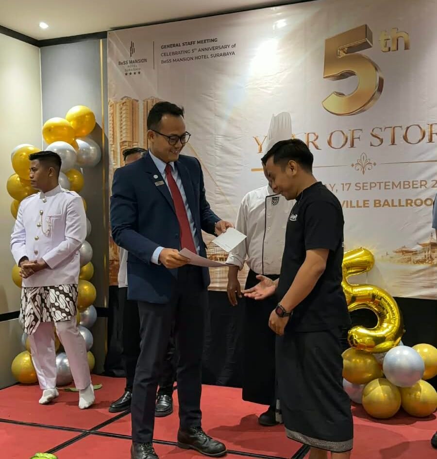 Manajemen BeSS Mansion Hotel Surabaya menyerahkan piagam penghargaan kepada perwakilan staf saat perayaan HUT ke-5 hotel dalam agenda General Staff Meeting (GSM) di Surabaya, Kamis (17/9/2026). (Foto: Dok. BeSS Mansion Hotel Surabaya)
