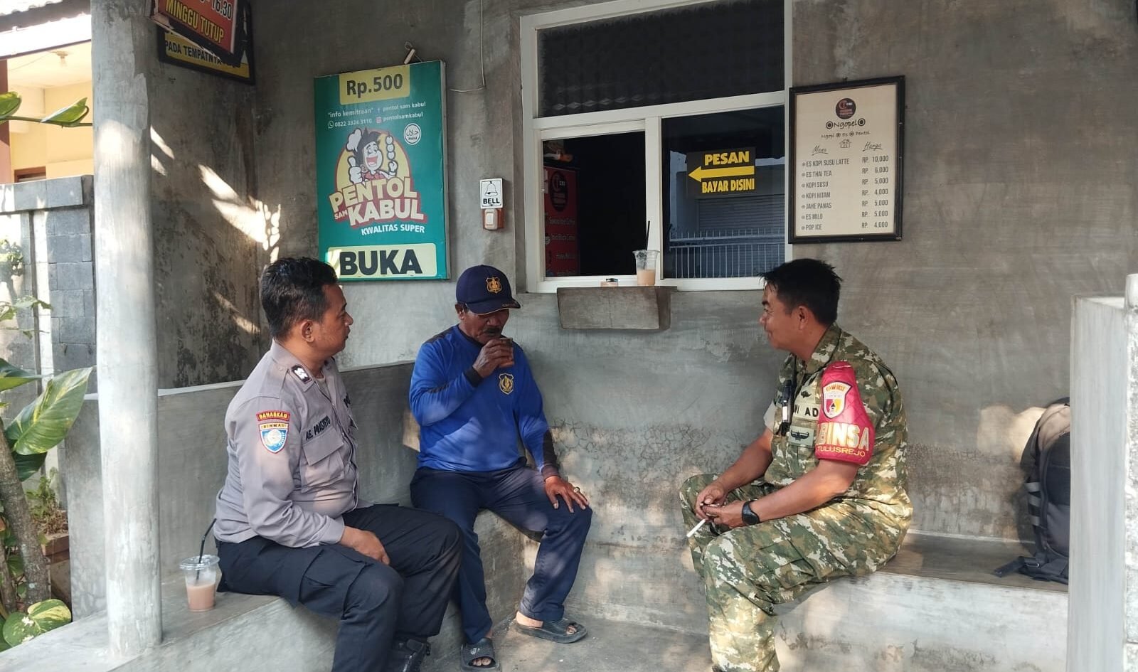 Potret keakraban Babinsa Tulusrejo, Serda Fajar, bersinergi bersama Bhabinkamtibmas saat menyempatkan diri berbincang santai dan mendengar aspirasi warga dalam kegiatan anjangsana kewilayahan, Sabtu (12/09).