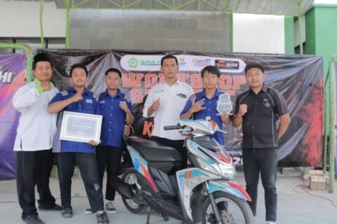 Siswa dan guru pembimbing SMK NU Tulungagung berfoto bersama memamerkan piala, piagam penghargaan, serta sepeda motor hasil karya mereka usai berhasil menyabet Juara Pertama dalam kompetisi "Samurai Education Painting 2026".