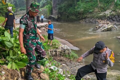 Aparat bersama warga saat membersihkan bantaran Sungai Brantas