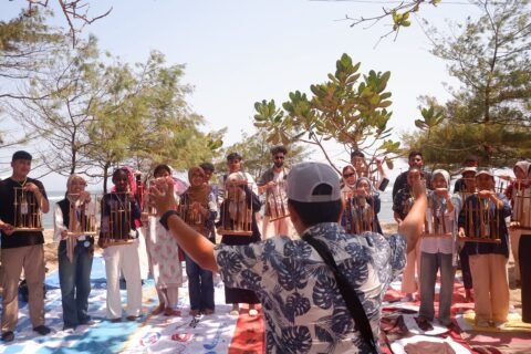 Mahasiswa internasional sedang bermain angklung di Pantai Balekambang